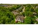 Aerial view of home situated in lush green trees and manicured lawns at 1258 Jamestowne Dr, Elon, NC 27244
