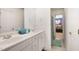 Bathroom featuring double sinks, a large mirror, and a door to the bedroom at 1258 Jamestowne Dr, Elon, NC 27244