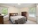 Bright bedroom with neutral walls, two large windows, and a wood dresser at 1258 Jamestowne Dr, Elon, NC 27244