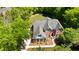 Aerial view of a beautiful red brick two-story home with a well-manicured lawn and mature trees at 1258 Jamestowne Dr, Elon, NC 27244