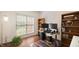 Bright home office featuring a large window, modern desk, and ample storage at 1258 Jamestowne Dr, Elon, NC 27244