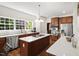 Bright kitchen featuring stainless steel appliances, a large island, and wooden cabinets at 1258 Jamestowne Dr, Elon, NC 27244