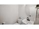 Clean powder room with a sleek vanity, round mirror, and modern fixtures at 1258 Jamestowne Dr, Elon, NC 27244