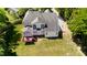 Aerial view of back of home with deck and spacious backyard on a sunny day at 1258 Jamestowne Dr, Elon, NC 27244