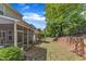 The backyard has a screened-in porch, lawn, retaining wall, and a partial view of a fence at 127 Deacon Ridge St, Wake Forest, NC 27587