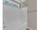 Clean white tiled bath/shower combo with window and chrome hardware at 127 Deacon Ridge St, Wake Forest, NC 27587