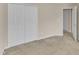 This bedroom features neutral paint, plush carpet, large closet and a doorway to another room at 127 Deacon Ridge St, Wake Forest, NC 27587