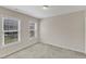 Well-lit bedroom features neutral paint, plush carpet, and two windows providing natural light at 127 Deacon Ridge St, Wake Forest, NC 27587