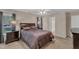 Carpeted main bedroom featuring a ceiling fan, window, furnishings, and ensuite bathroom at 127 Deacon Ridge St, Wake Forest, NC 27587