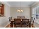 Dining room with wood table, chandelier, wood floors, and window view at 127 Deacon Ridge St, Wake Forest, NC 27587