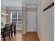 Inviting entryway with wood floors, coat rack, and view into dining room with window at 127 Deacon Ridge St, Wake Forest, NC 27587