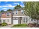 Attractive townhouse with green lawn, one-car garage, and tree in the front yard at 127 Deacon Ridge St, Wake Forest, NC 27587