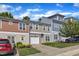 Street view of townhouses with neat lawns, one-car garages, and car parked in driveway at 127 Deacon Ridge St, Wake Forest, NC 27587