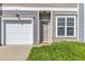 Well-kept townhouse with a one-car garage and front door, and lush lawn at 127 Deacon Ridge St, Wake Forest, NC 27587