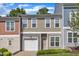 Two-story townhouse with tan siding, white trim, front lawn, and attached one-car garage at 127 Deacon Ridge St, Wake Forest, NC 27587