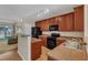 Well-lit kitchen features wood cabinets, laminate countertops, and black appliances at 127 Deacon Ridge St, Wake Forest, NC 27587