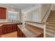 The kitchen features laminate countertops, a sink, and views of the staircase at 127 Deacon Ridge St, Wake Forest, NC 27587