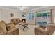 A bright living room with fireplace, ceiling fan, and sliding glass door at 127 Deacon Ridge St, Wake Forest, NC 27587