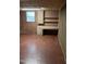 Functional basement showcasing exposed brick walls and built-in shelving, perfect for storage or workshop activities at 1706 Carthage St, Sanford, NC 27330