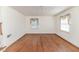 Bright bedroom with hardwood floors, two windows, and a ceiling fan at 1706 Carthage St, Sanford, NC 27330