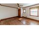Bedroom featuring hardwood floors, wood trim, and natural light at 1706 Carthage St, Sanford, NC 27330