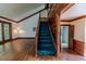 Inviting entryway with hardwood floors and a staircase with a wood banister at 1706 Carthage St, Sanford, NC 27330