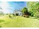Charming home surrounded by lush greenery, showcasing a well-maintained lawn and a picturesque setting at 1706 Carthage St, Sanford, NC 27330