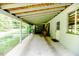 Covered patio featuring exposed beams, concrete floor, and outdoor space at 1706 Carthage St, Sanford, NC 27330