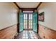 Inviting foyer features a brick floor, wood paneled wainscoting, and double doors leading to the outdoors at 1706 Carthage St, Sanford, NC 27330