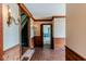 Open foyer featuring brick flooring, wood trim, and a view of the staircase and adjacent rooms at 1706 Carthage St, Sanford, NC 27330