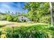 Inviting two-story home with a well-manicured lawn, mature trees, and colorful flowerbeds enhancing its curb appeal at 1706 Carthage St, Sanford, NC 27330