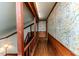 Hallway featuring hardwood floors, wood trim, and decorative wallpaper at 1706 Carthage St, Sanford, NC 27330