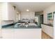 Bright kitchen with white cabinets, green countertops and tiled floors, ready for your personal touch at 1706 Carthage St, Sanford, NC 27330