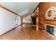 Open-concept living room featuring a staircase, fireplace, and hardwood floors for a spacious feel at 1706 Carthage St, Sanford, NC 27330