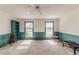 Spacious living room with two windows, neutral carpet, and wainscoting on the lower walls at 1706 Carthage St, Sanford, NC 27330