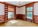 Bright living room with built-in shelves, two windows, wood trim and a decorative chandelier at 1706 Carthage St, Sanford, NC 27330