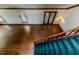 Spacious living room showcasing hardwood floors, natural light from windows, and access to a staircase and doorway at 1706 Carthage St, Sanford, NC 27330