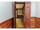 View of a room with hardwood trim and access to a room with a fireplace through an open door at 1706 Carthage St, Sanford, NC 27330