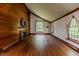 Inviting living room with hardwood floors, wood-paneled walls, and large windows offering natural light at 1706 Carthage St, Sanford, NC 27330