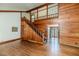 Living room featuring a wooden staircase, fireplace, and hardwood floors for a spacious design at 1706 Carthage St, Sanford, NC 27330