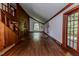Spacious living room featuring wood paneling, hardwood floors, and abundant natural light at 1706 Carthage St, Sanford, NC 27330