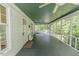Inviting screened porch with a green ceiling, providing a relaxing outdoor living space at 1706 Carthage St, Sanford, NC 27330