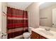 Functional bathroom featuring a shower with a stylish curtain, a toilet, and a vanity sink at 1743 Longshadow Dr, Burlington, NC 27217