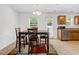 Bright dining area with table, four chairs, and outdoor view from a nearby door and windows at 1743 Longshadow Dr, Burlington, NC 27217