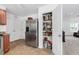 Well-organized kitchen pantry with stainless steel refrigerator and access to the living room at 1743 Longshadow Dr, Burlington, NC 27217