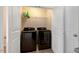Bright laundry room featuring a modern washer and dryer set and ample shelving for storage at 1743 Longshadow Dr, Burlington, NC 27217