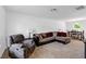 Inviting living room features neutral carpeting, a comfortable reclining chair, and a sectional couch at 1743 Longshadow Dr, Burlington, NC 27217