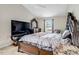 Spacious main bedroom with luxurious decor, a large window, and plush carpeting throughout at 1743 Longshadow Dr, Burlington, NC 27217
