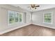 Bright bedroom with plantation shutters, hardwood floors, and ceiling fan at 201 Bog Hill Ln, Cary, NC 27519