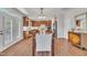Dining room with wood floors connecting to modern kitchen and access to exterior at 201 Bog Hill Ln, Cary, NC 27519